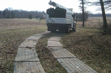 arborist truck driving on track mats