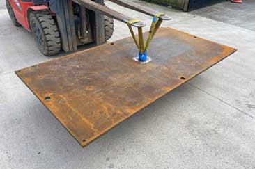 Road plate being lifted up with a forklift