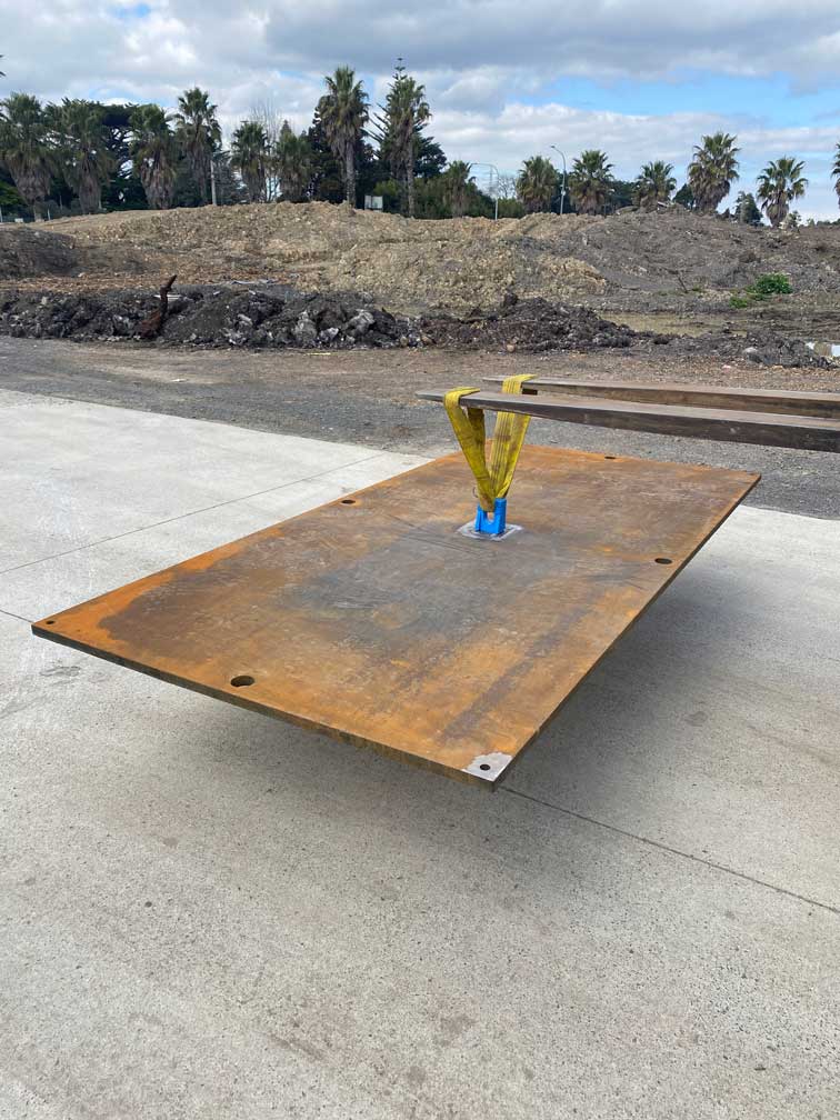 Road plate being picked up by a forklift